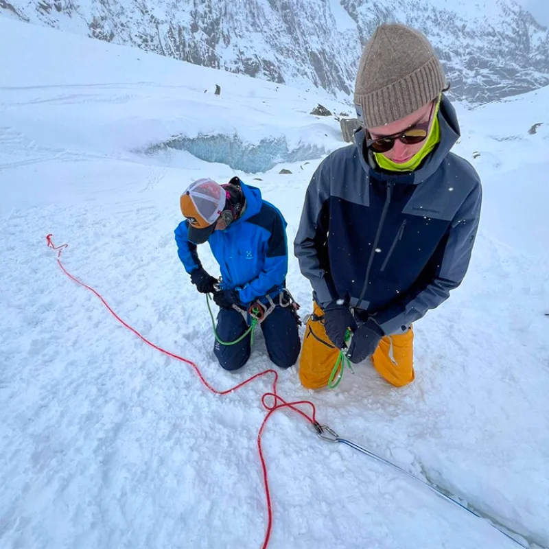 Participants learning glacier travel safety and crevasse rescue skills in the Alps