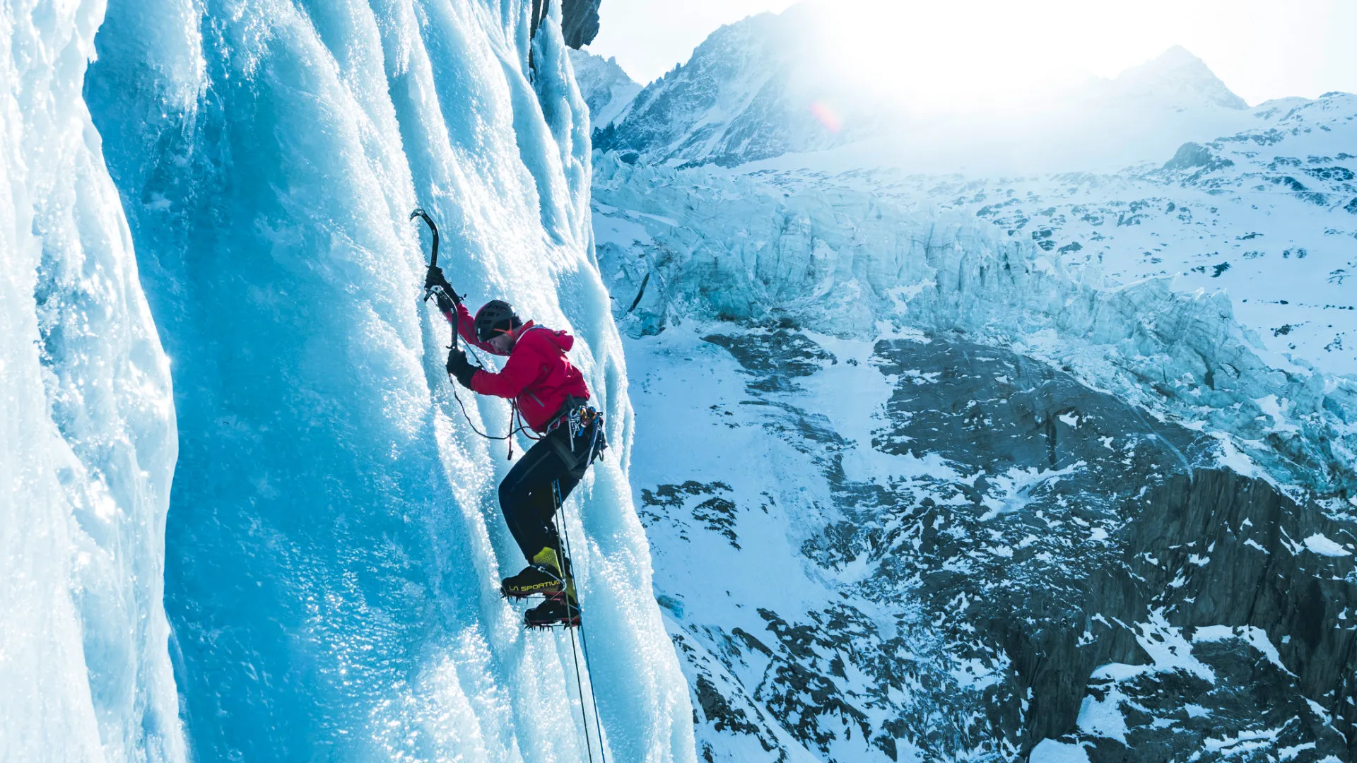 IFMGA guide teaching ice climbing techniques on a frozen waterfall in Chamonix