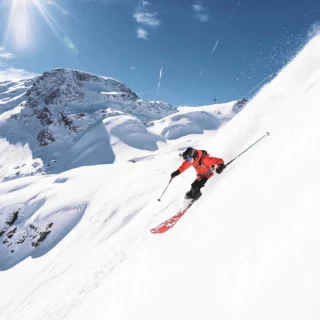 Skier descending a powder face in the Verbier freeride area