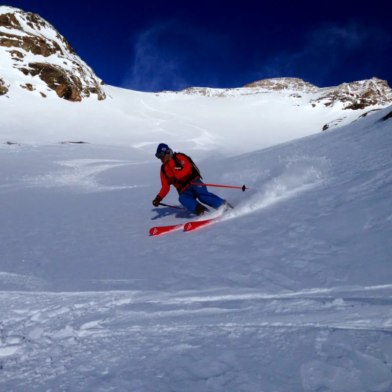 IFMGA guide leading a skier through untouched snow in the Aosta Valley