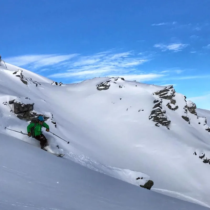 Freeride skier descending steep powder slopes in the Chamonix backcountry