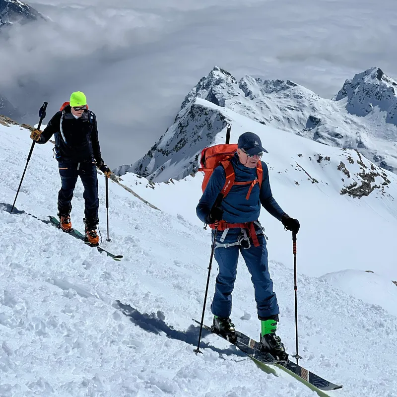 Ski mountaineers climbing a glacier ridge in the Monte Rosa massif