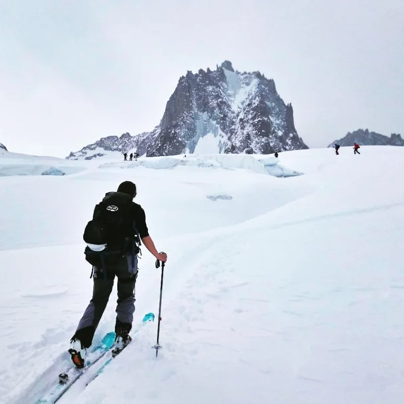 Ski tourers ascending a glacier slope in the Alps