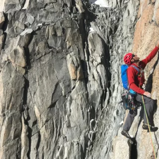 Climber ascending a famous Chamonix rock face