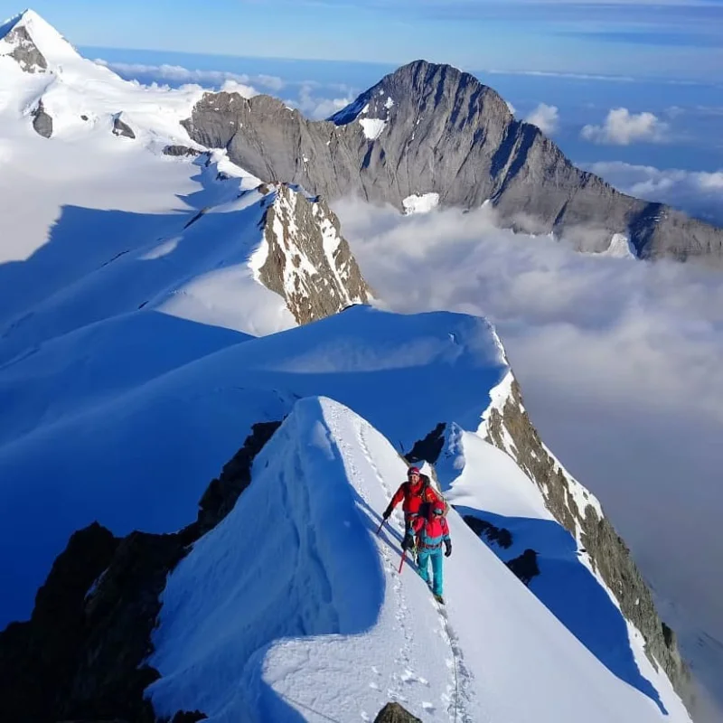 Mountaineering students practicing belaying on a mountain ridge