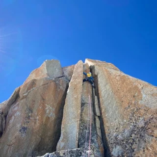 Climber ascending a granite wall in Chamonix