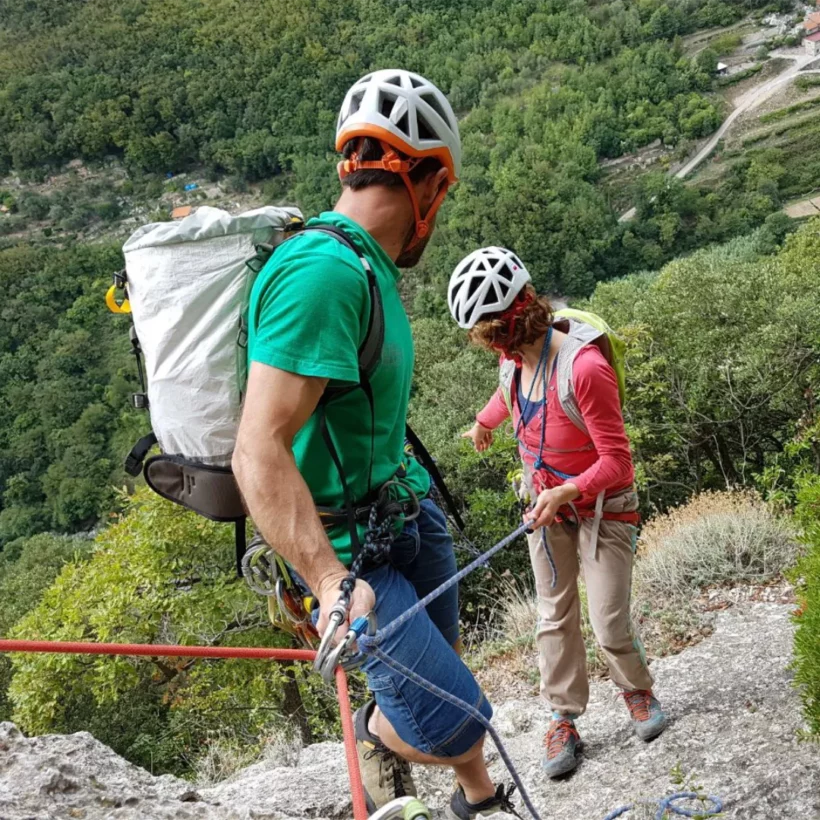 IFMGA guide coaching lead climbing techniques on natural rock